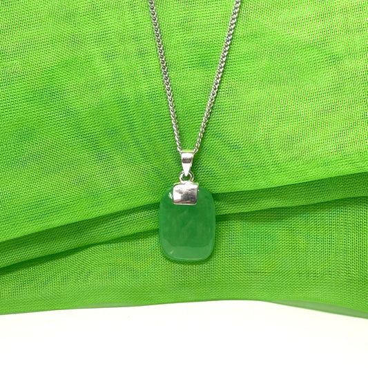 Green jade cushion shaped silver necklace pendant, a timeless design