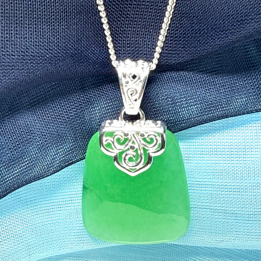 Green real jade necklace with a large shaped and patterned pendant with chain