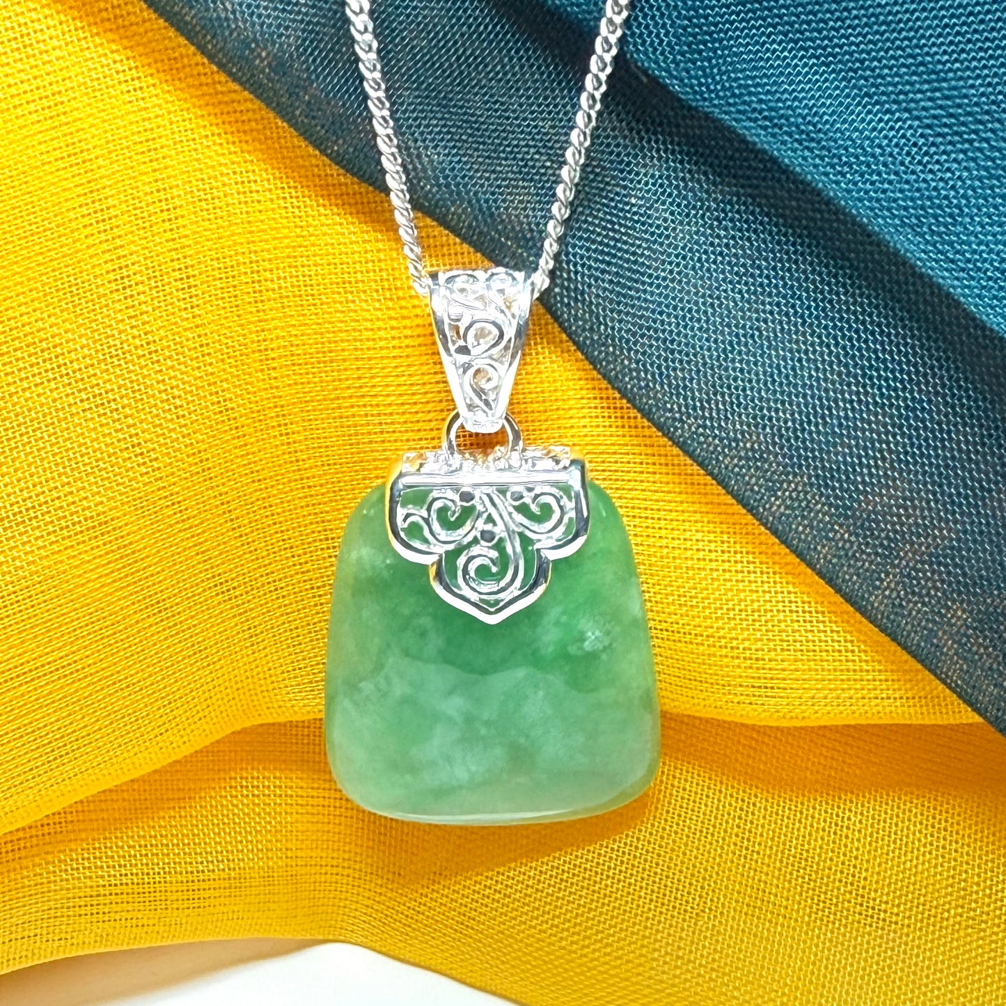 Green real jade necklace with a large shaped and patterned pendant