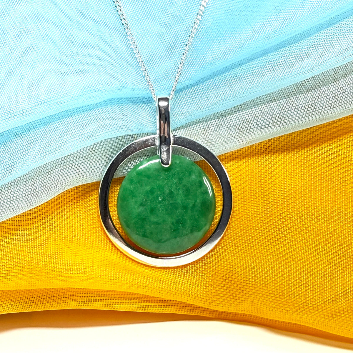 A large gorgeous sterling silver green real jade necklace halo style round pendant