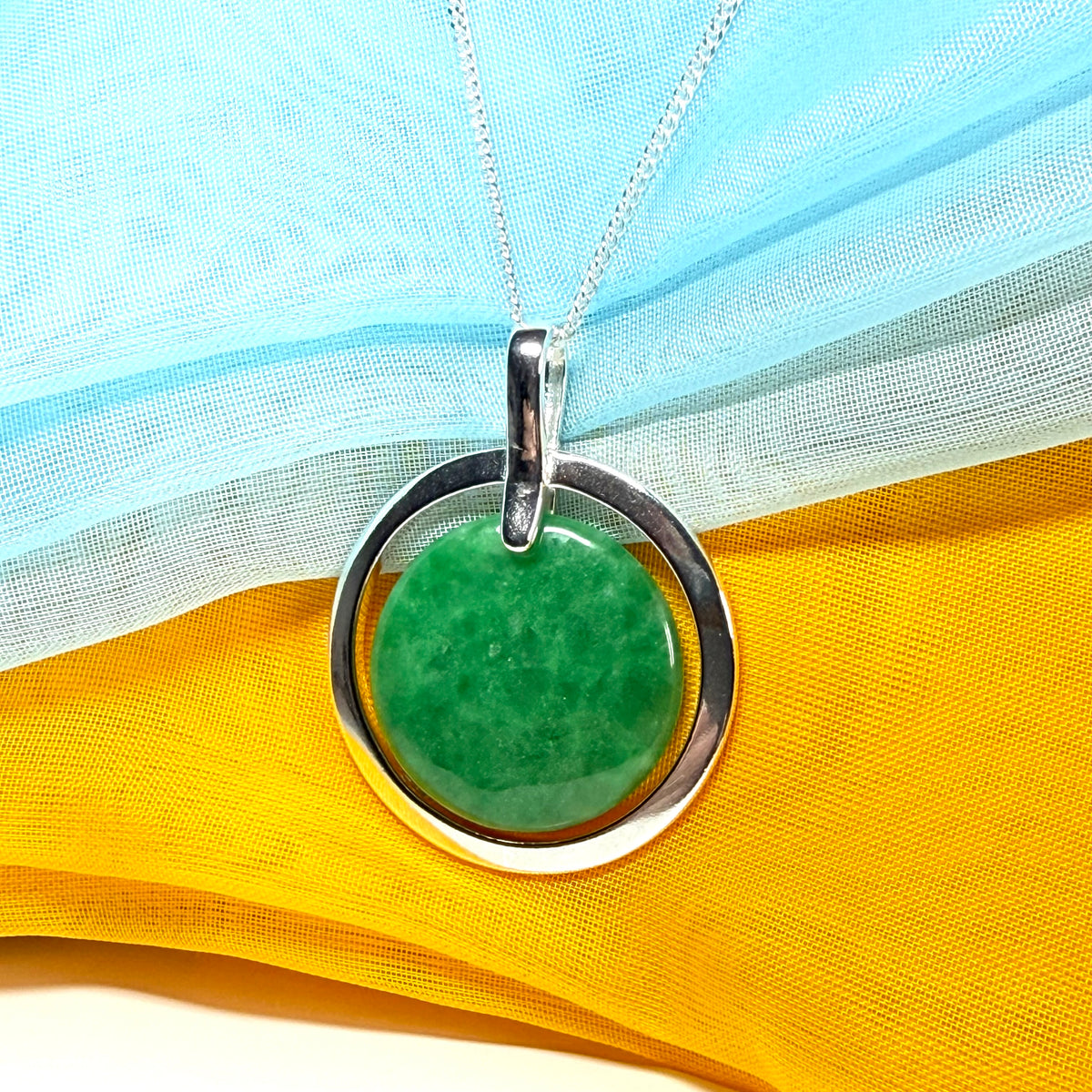 A large gorgeous sterling silver green real jade necklace halo style round pendant
