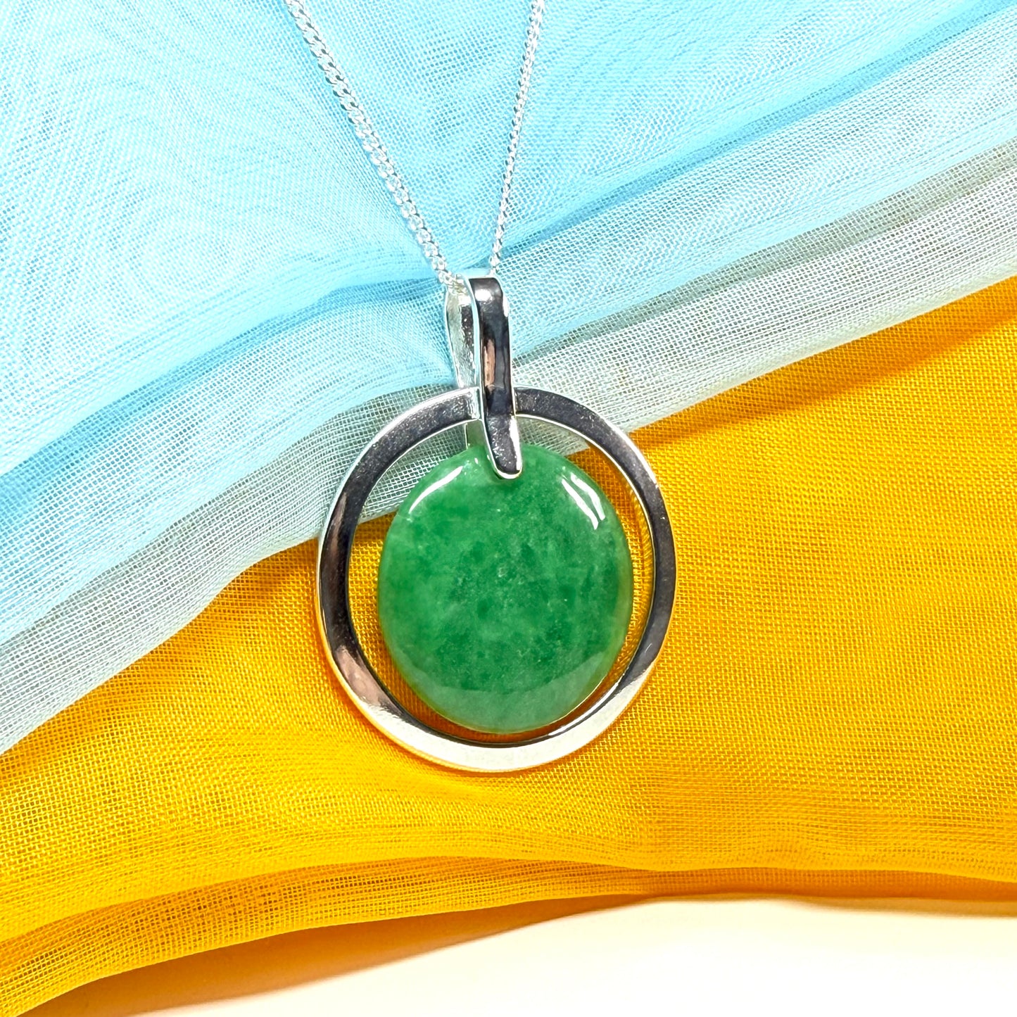 A large gorgeous sterling silver green real jade necklace halo style round pendant