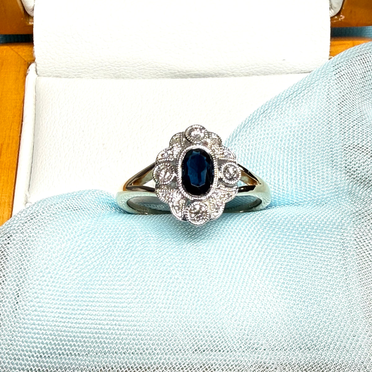 Dark blue sapphire and diamond yellow gold cluster ring