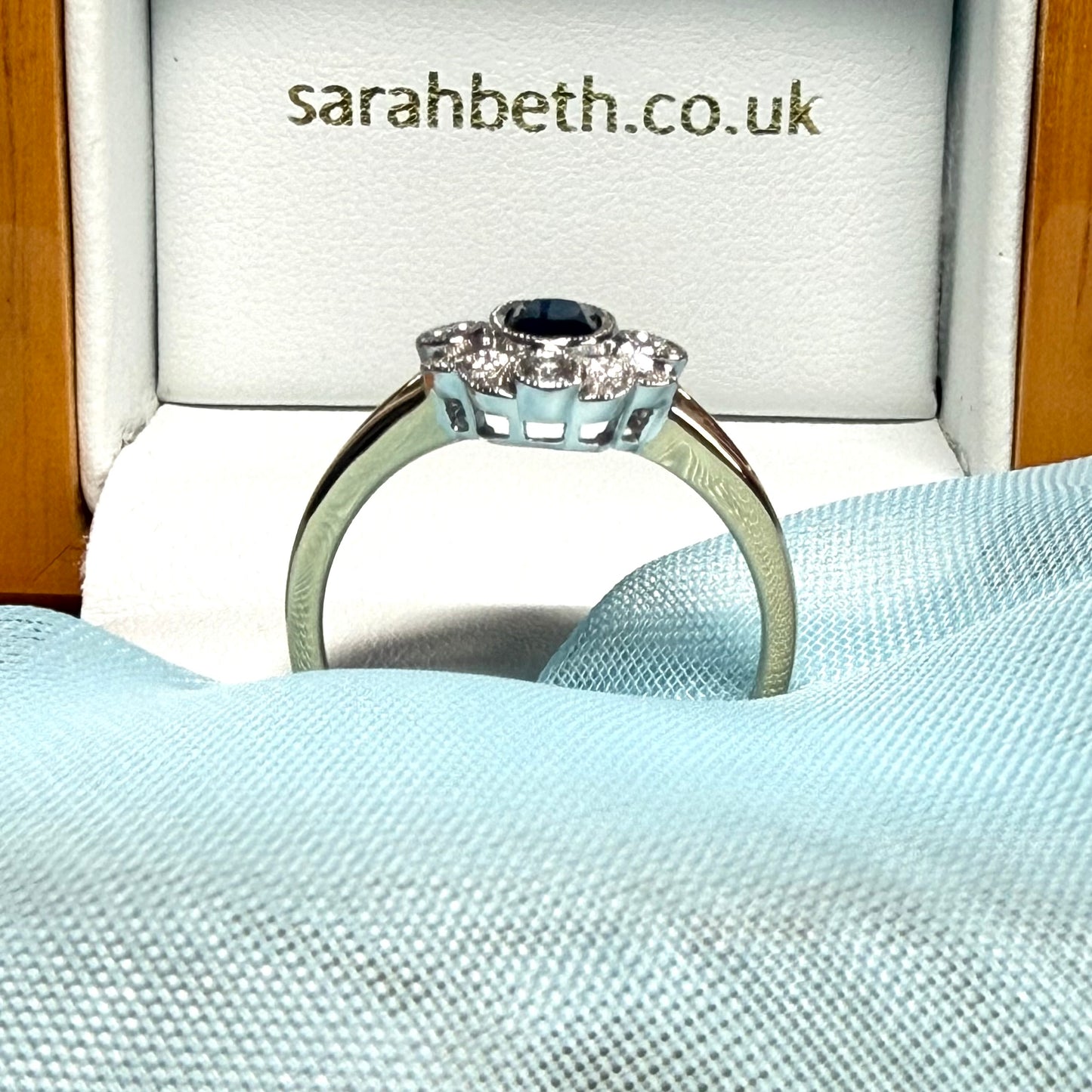 Dark blue sapphire and diamond yellow gold cluster ring