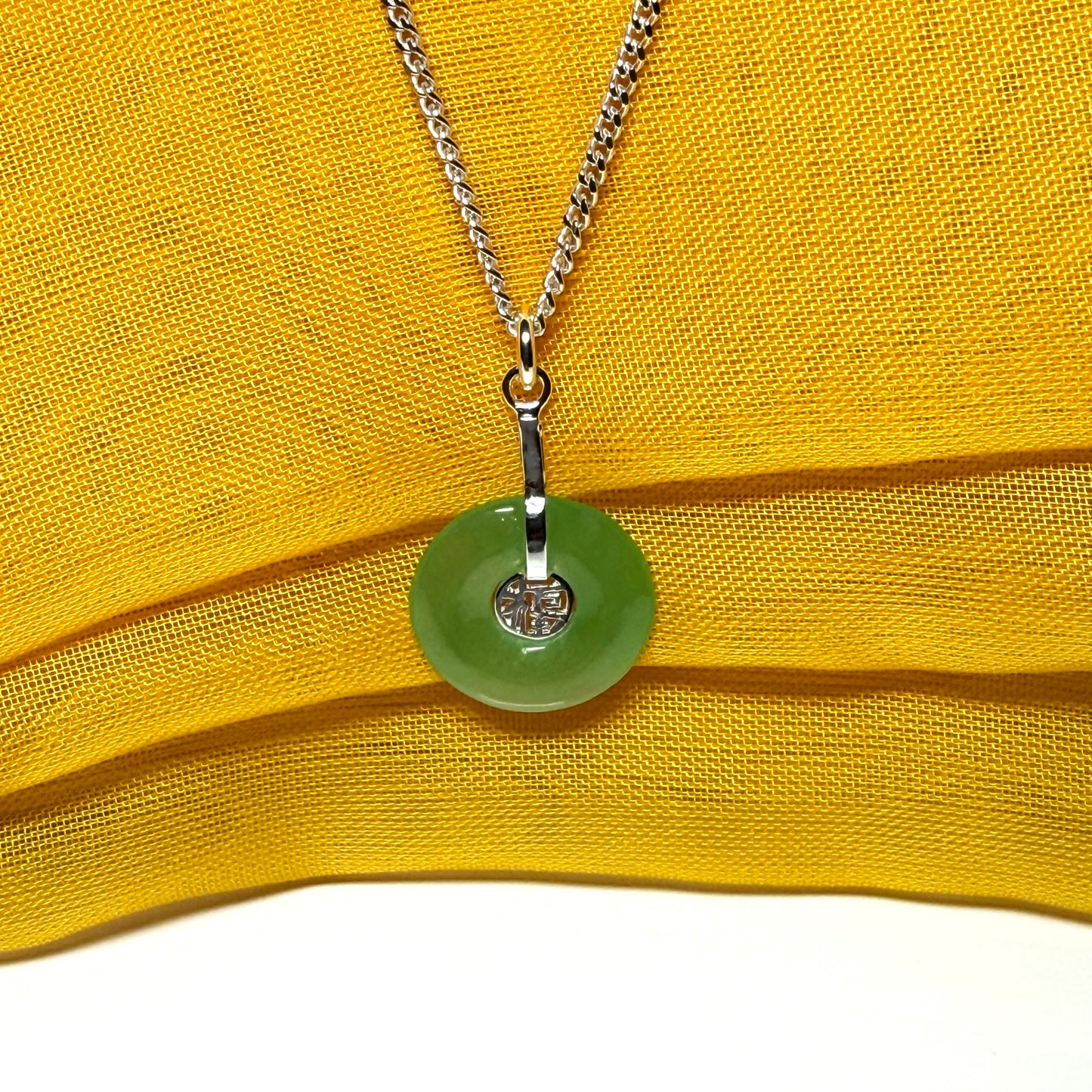 Real green jade necklace with a round pendant sterling silver and a chain included