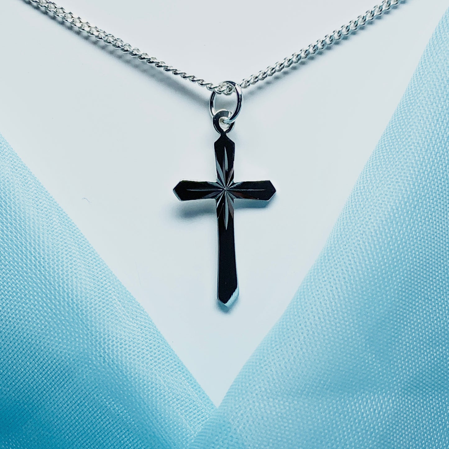 Small sterling silver diamond cut cross necklace including chain