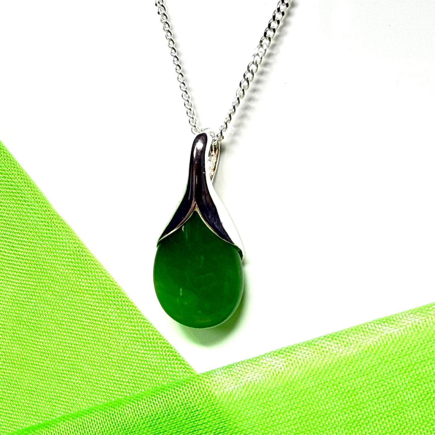 A real green jade pendant teardrop with a pear shaped necklace, with chain included