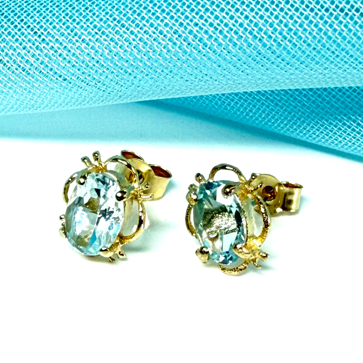 Yellow Gold Light Blue Topaz Stud Earrings Oval Shape
