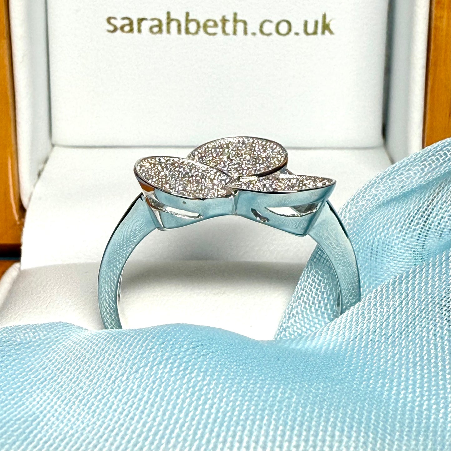 Ladies sterling silver cluster ring with a triple round shaped fancy design