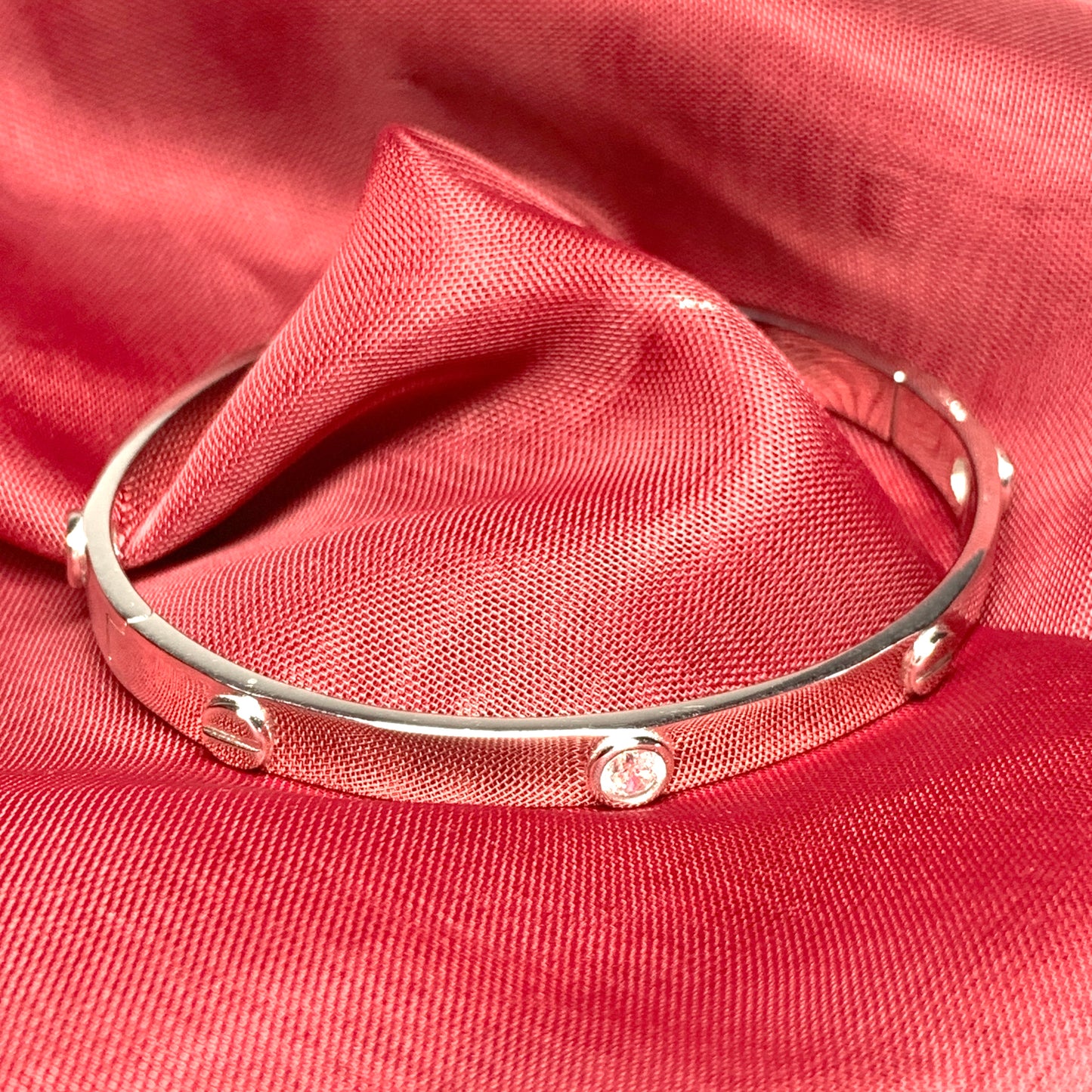 Ladies stone set oval bangle screw head design patterned sterling silver