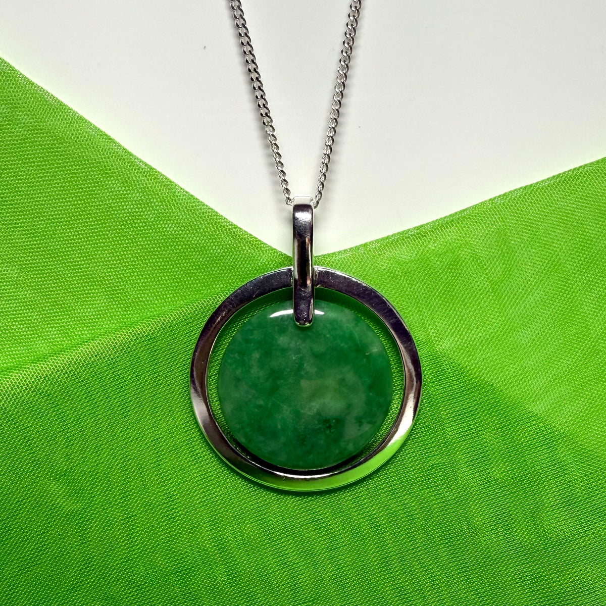 Large silver round shaped dark green real jade necklace with a chain