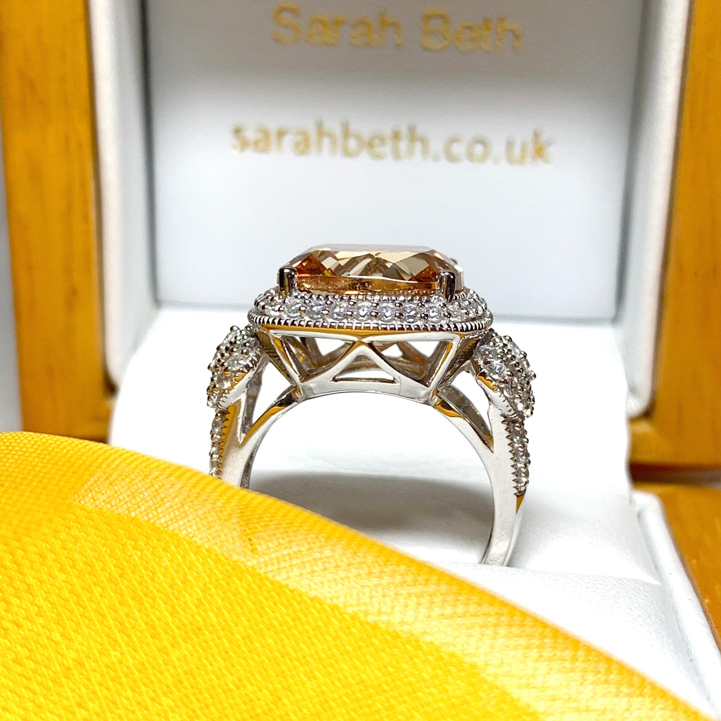 Large topaz coloured cocktail ring with decorated shoulders