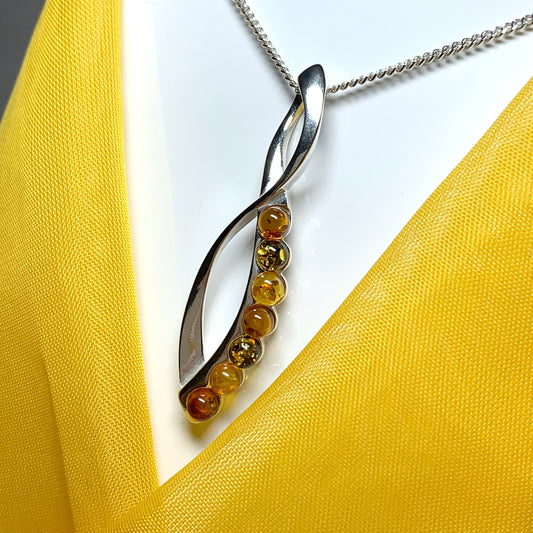 Multi colour amber figure of eight drop sterling silver necklace