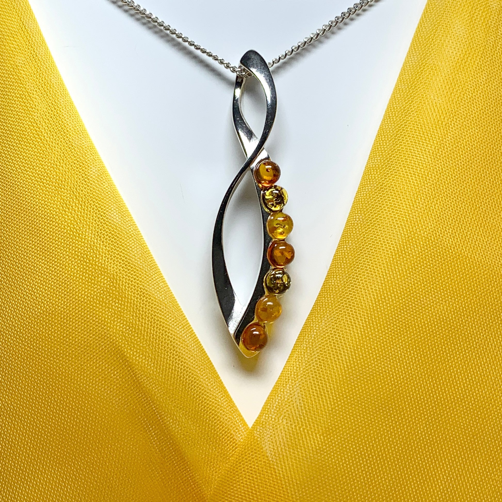 Multi colour amber figure of eight drop sterling silver necklace