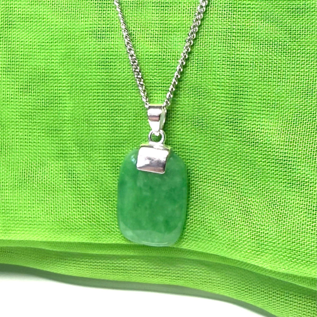 Necklace pendant having real green jade sterling silver cushion shaped with a chain included