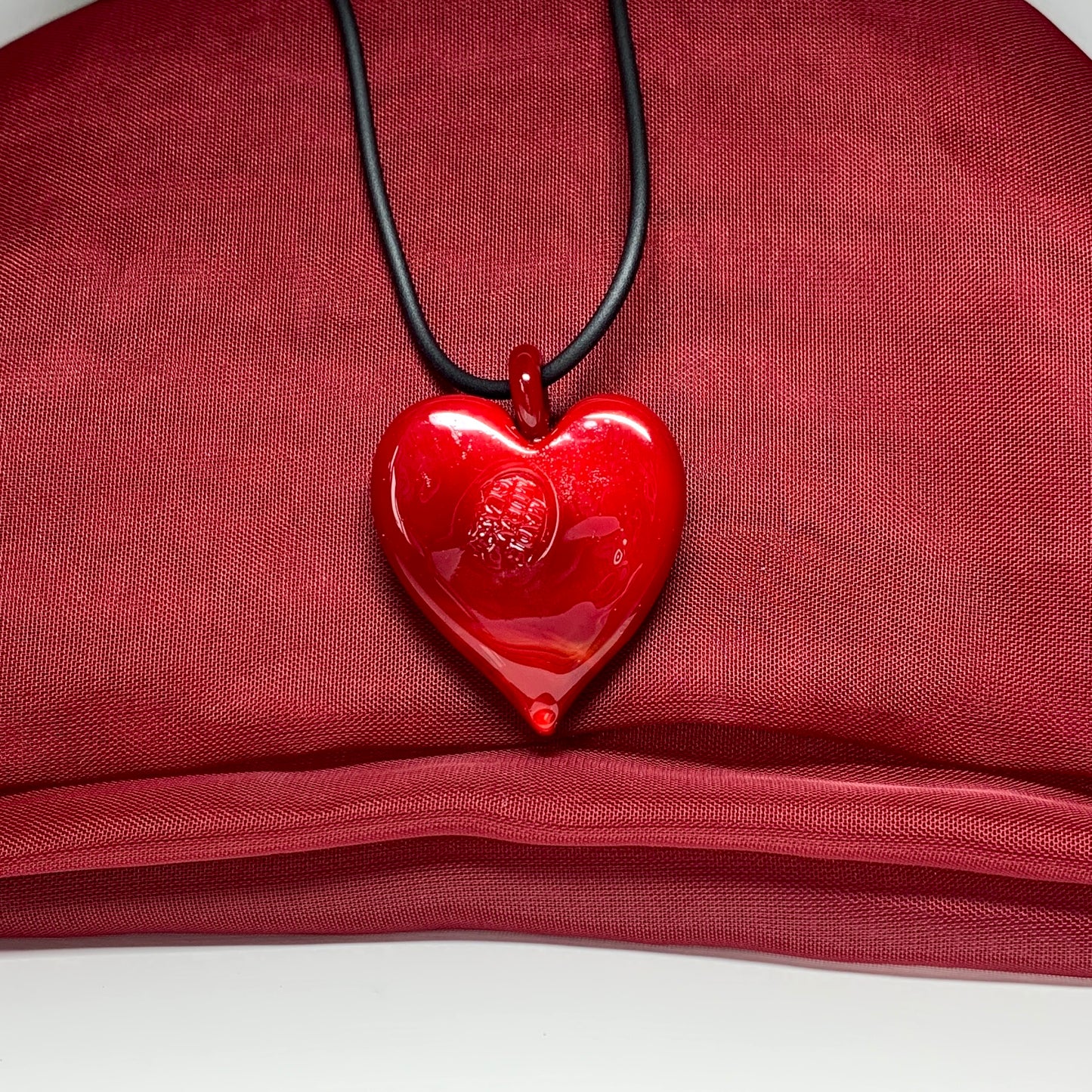Necklace real Murano glass bright red heart drop pendant on a black cord showing the back with the genuine Murano stamp