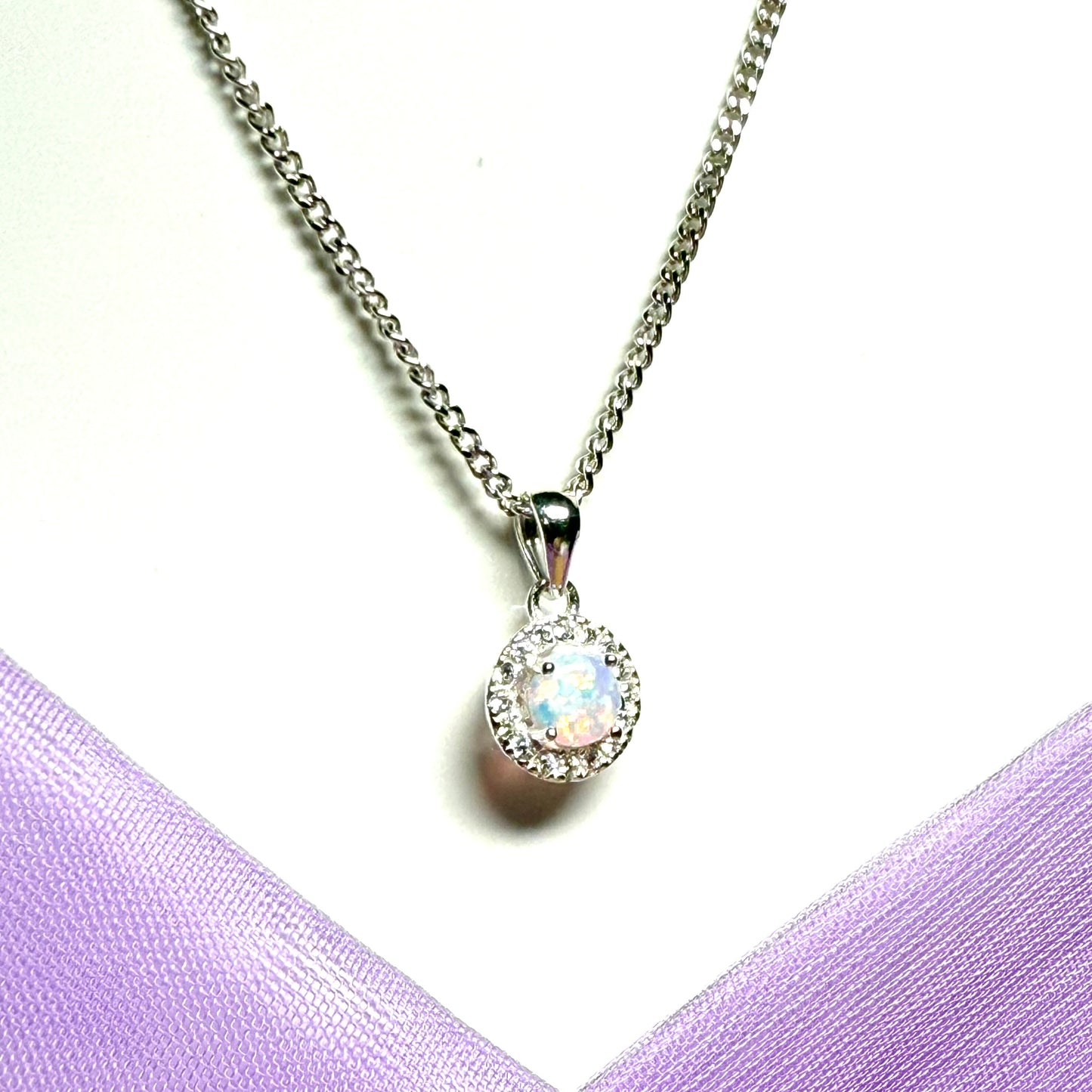 Opal necklace sterling silver round shaped and cubic zirconia pendant with a classic round design to it