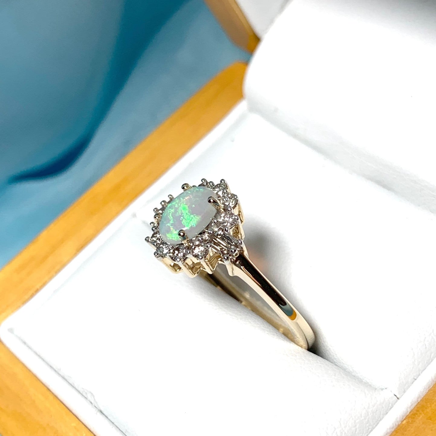 Opal and diamond yellow gold cluster ring with baguette diamonds