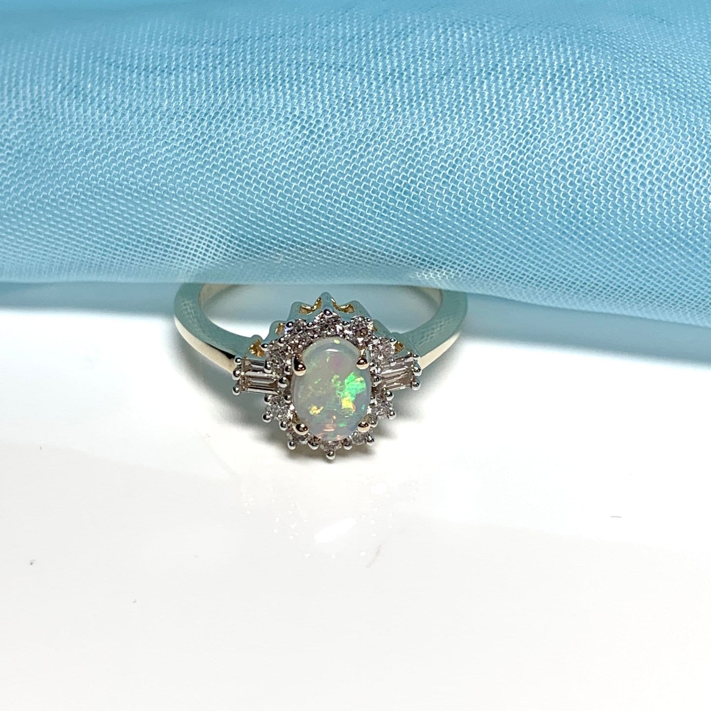 Opal and diamond yellow gold cluster ring with baguette diamonds