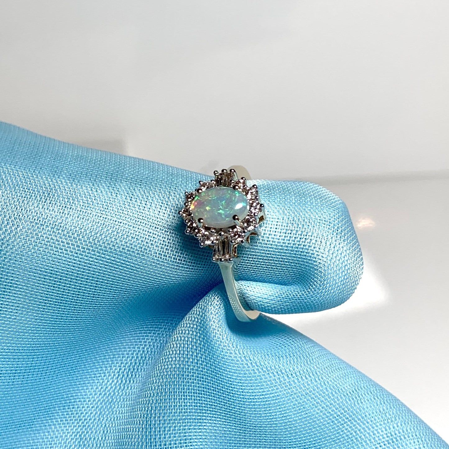 Opal and diamond yellow gold cluster ring with baguette diamonds