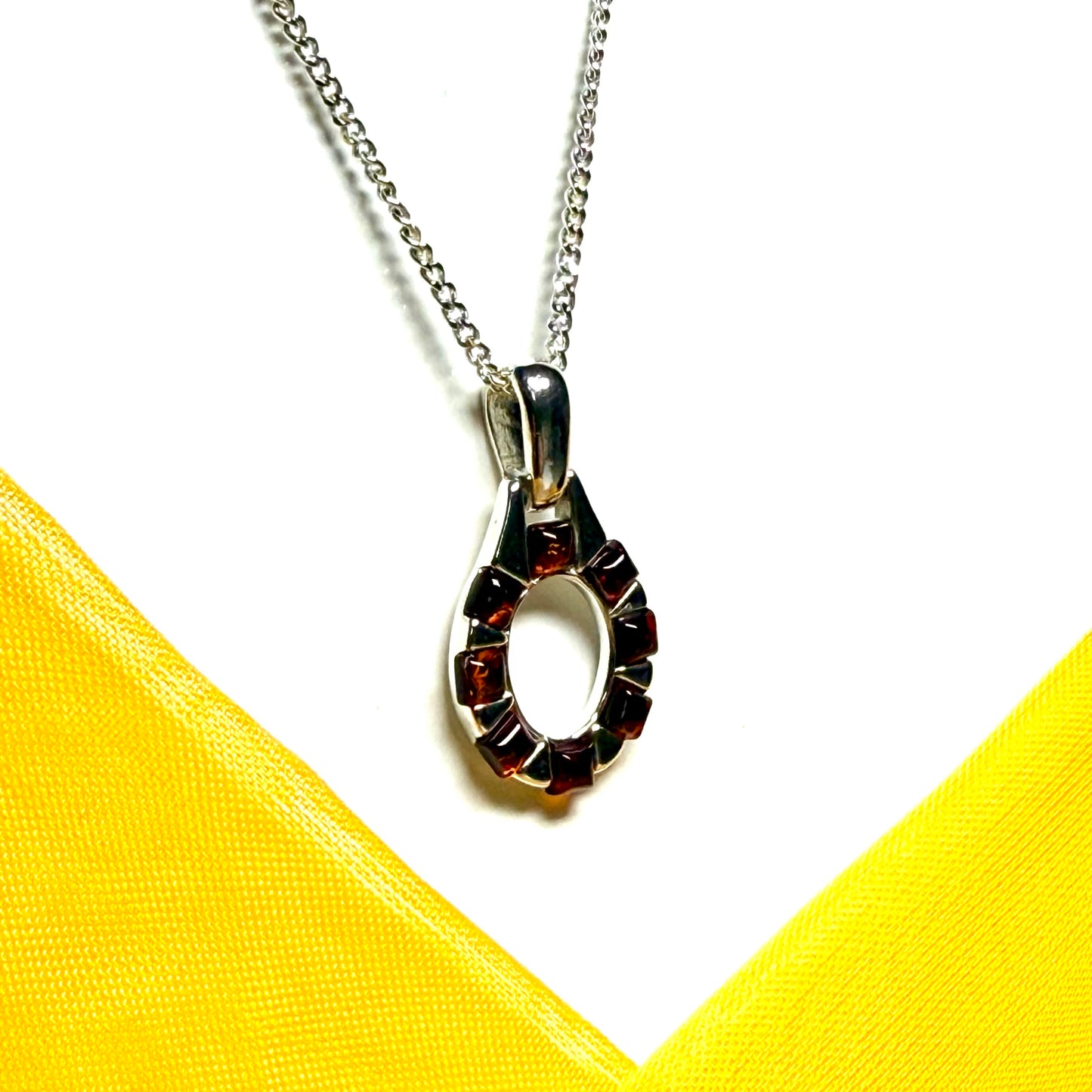 Open oval amber necklace sterling silver pendant