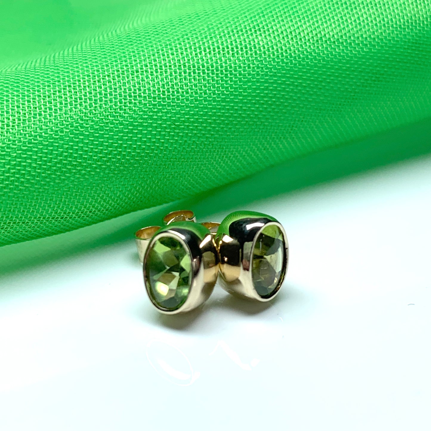 Oval Shaped Peridot Yellow Gold Stud Earrings