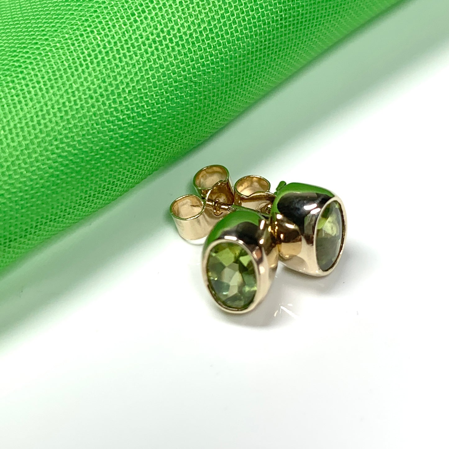 Oval Shaped Peridot Yellow Gold Stud Earrings