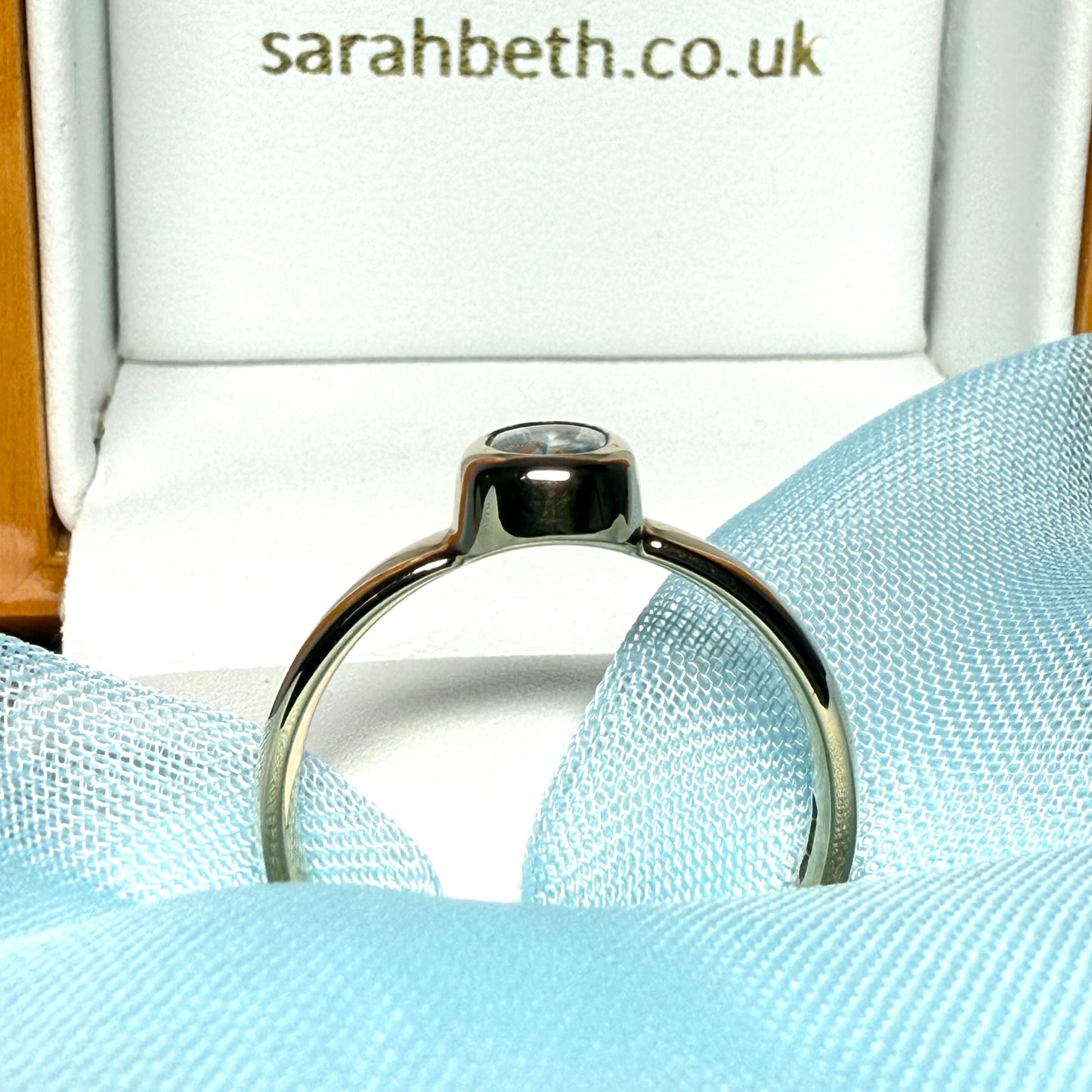 Oval shaped real blue topaz yellow gold dress ring smooth rubbed over setting