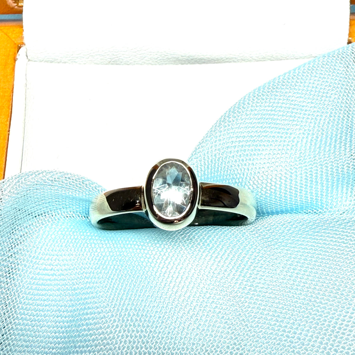 Oval shaped real blue topaz yellow gold dress ring smooth rubbed over setting
