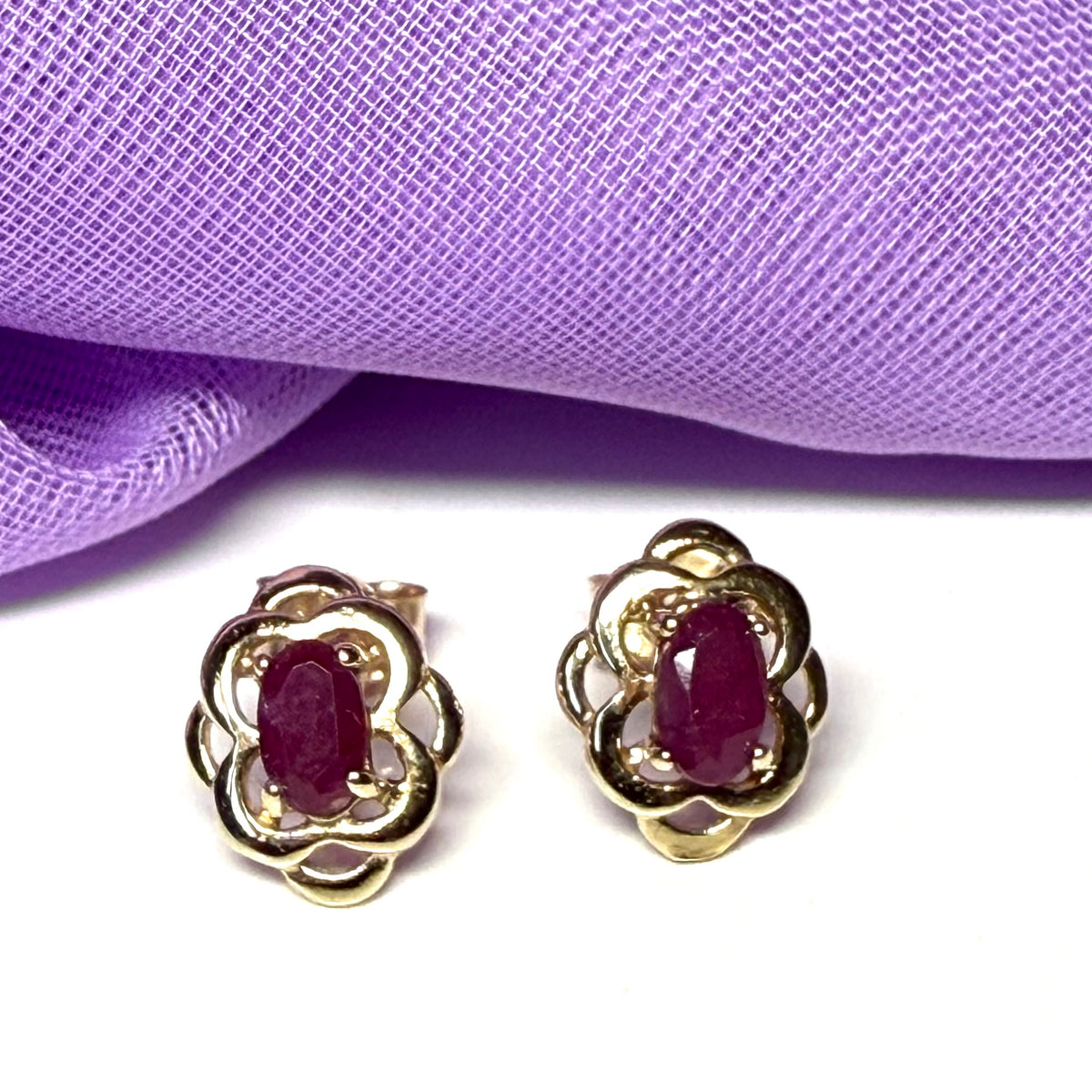 Oval shaped real ruby yellow gold stud earrings