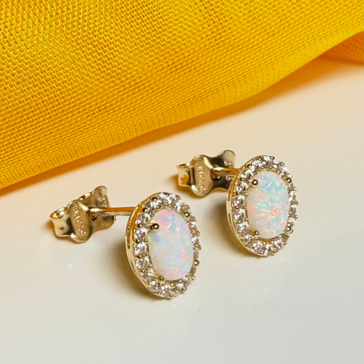 Oval shaped stud cluster earrings opal and cubic zirconia yellow gold
