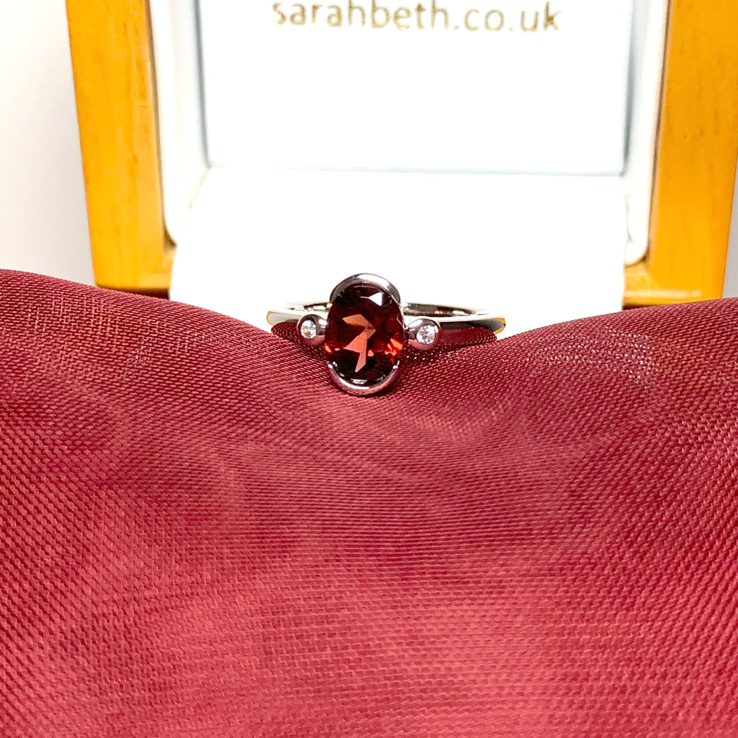 Oval garnet and cubic zirconia sterling silver ring