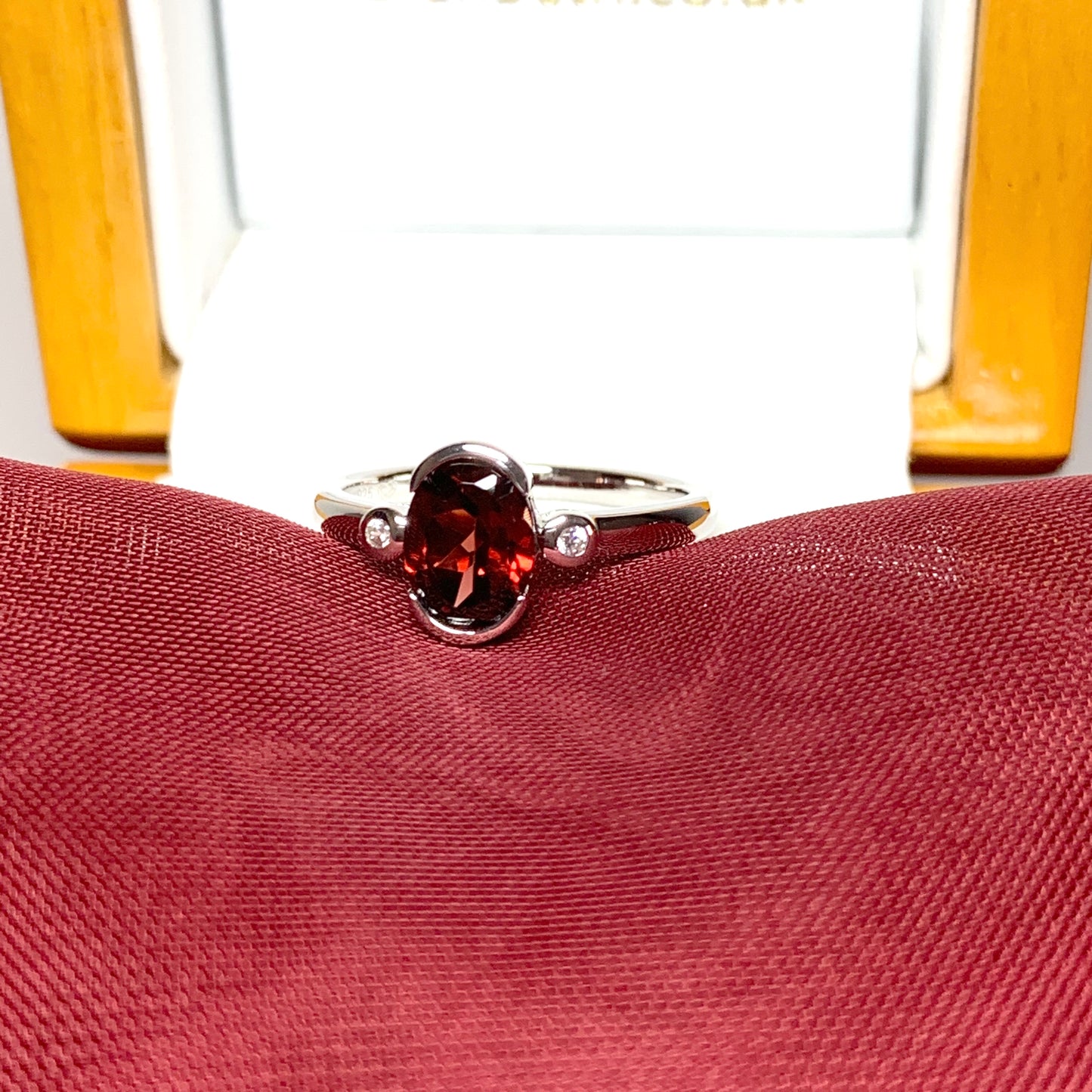 Oval garnet and cubic zirconia sterling silver ring