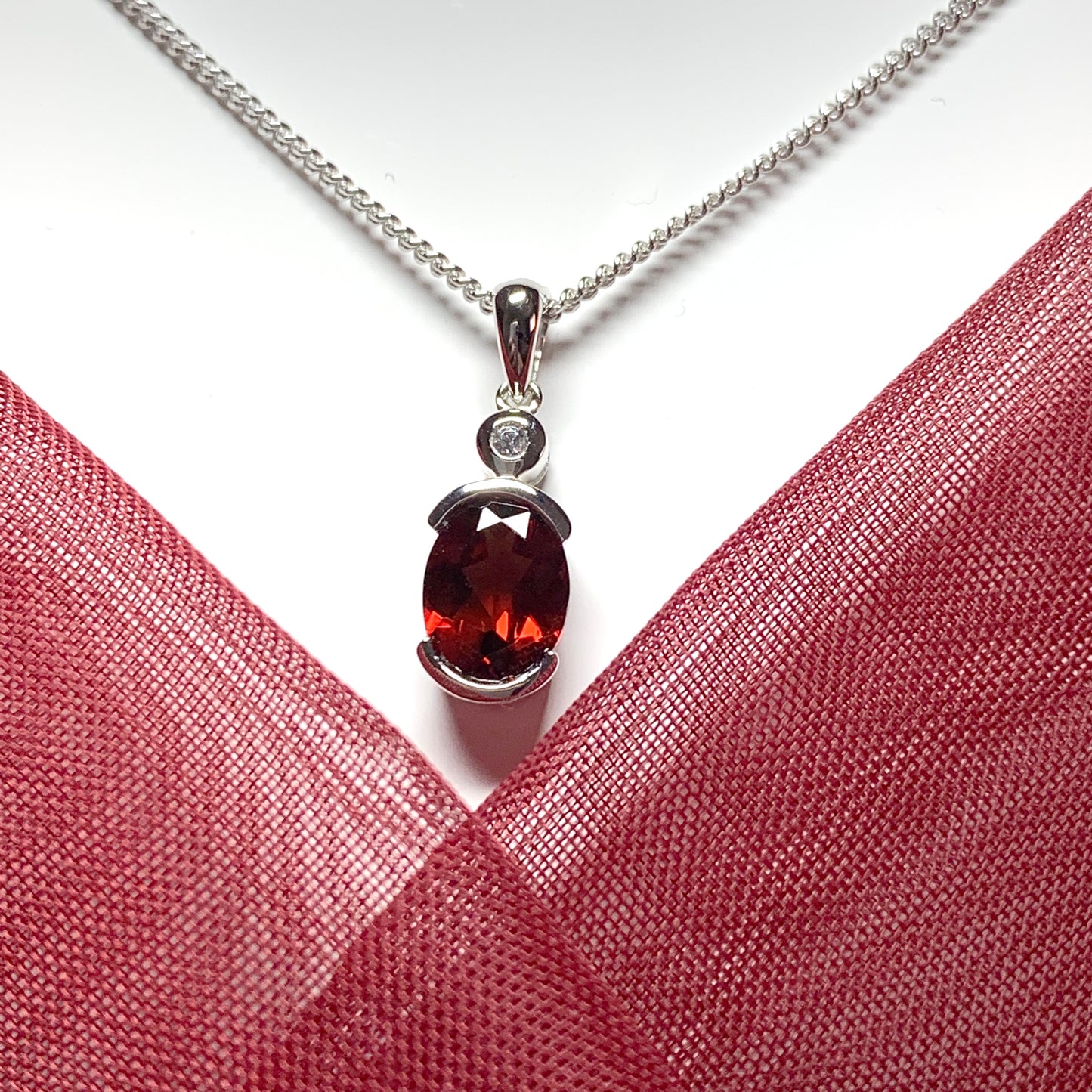 Oval garnet and cubic zirconia sterling silver necklace