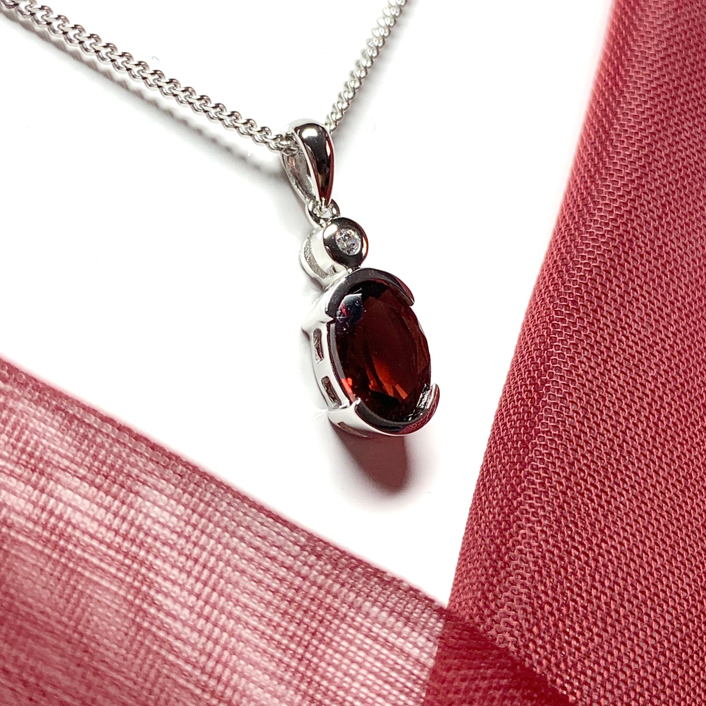 Oval garnet and cubic zirconia sterling silver necklace