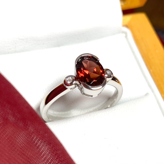 Oval garnet and cubic zirconia sterling silver ring