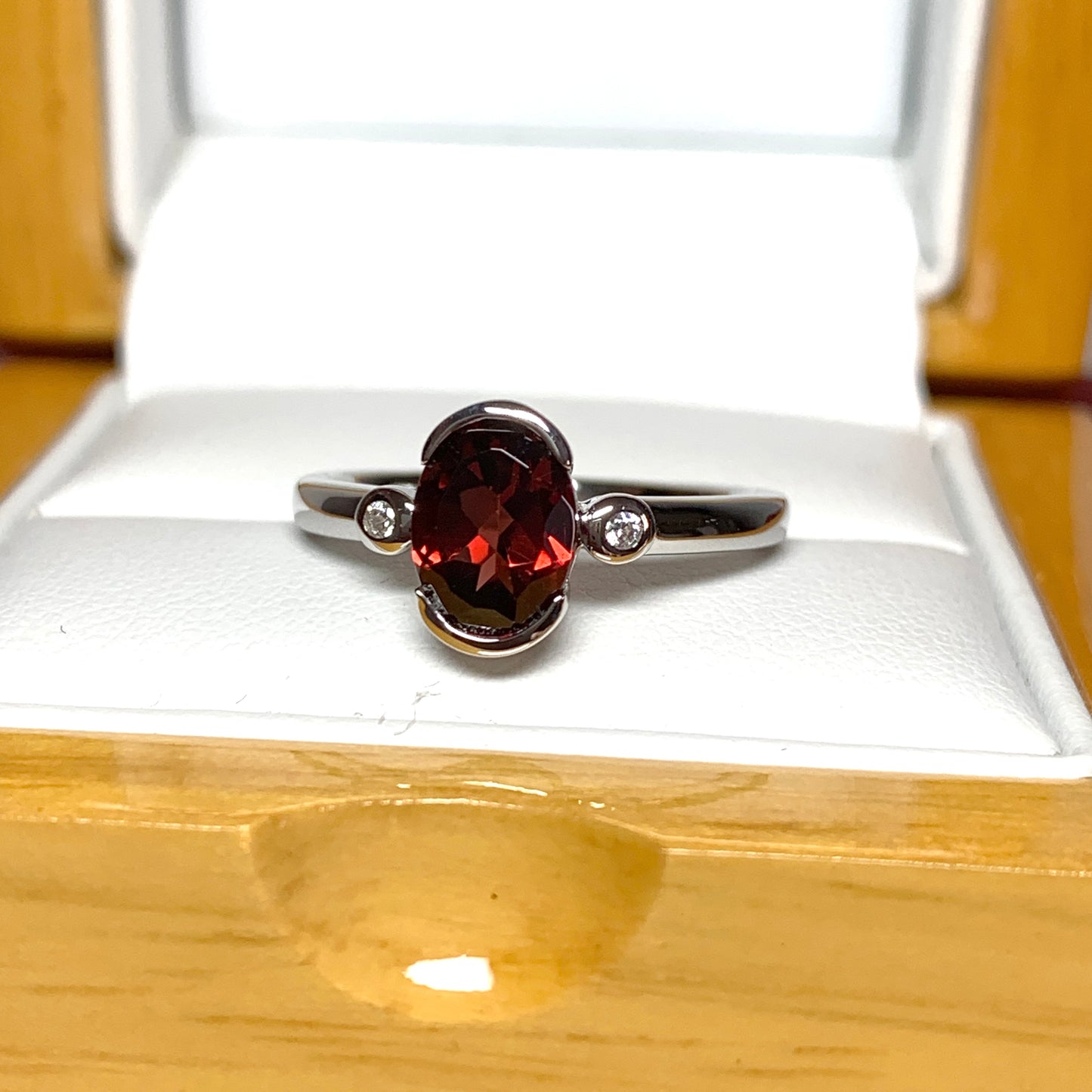 Oval garnet and cubic zirconia sterling silver ring