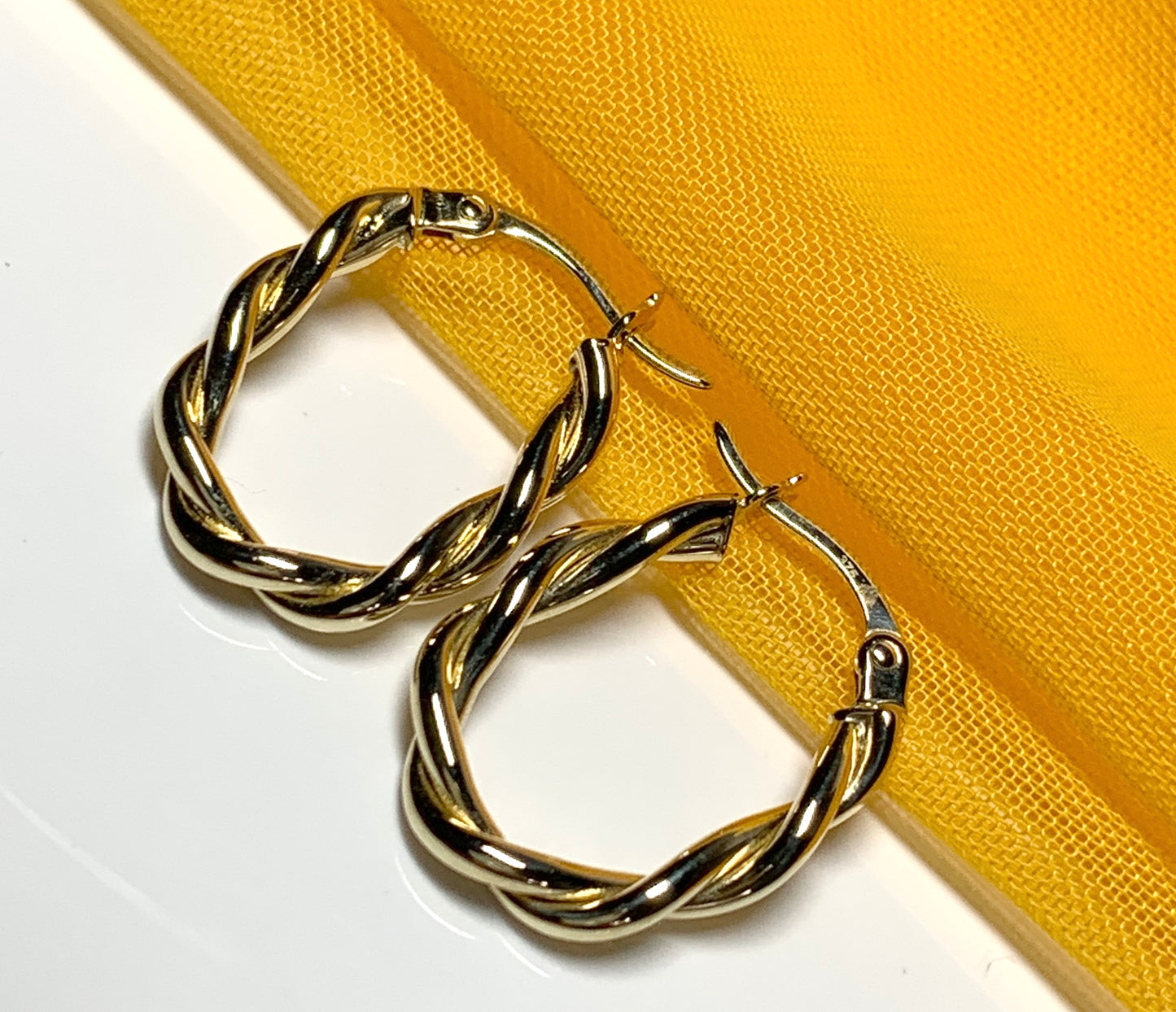 Oval hoop earrings yellow gold twisted