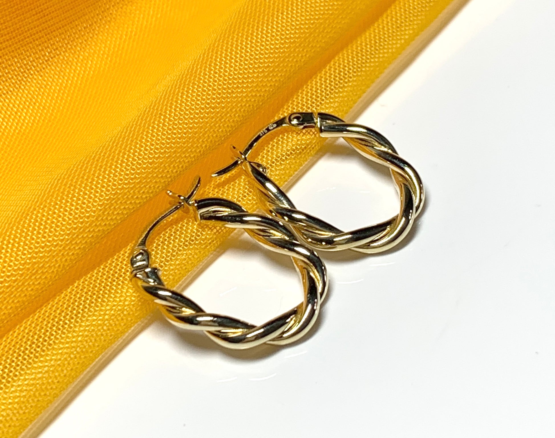 Oval hoop earrings yellow gold twisted
