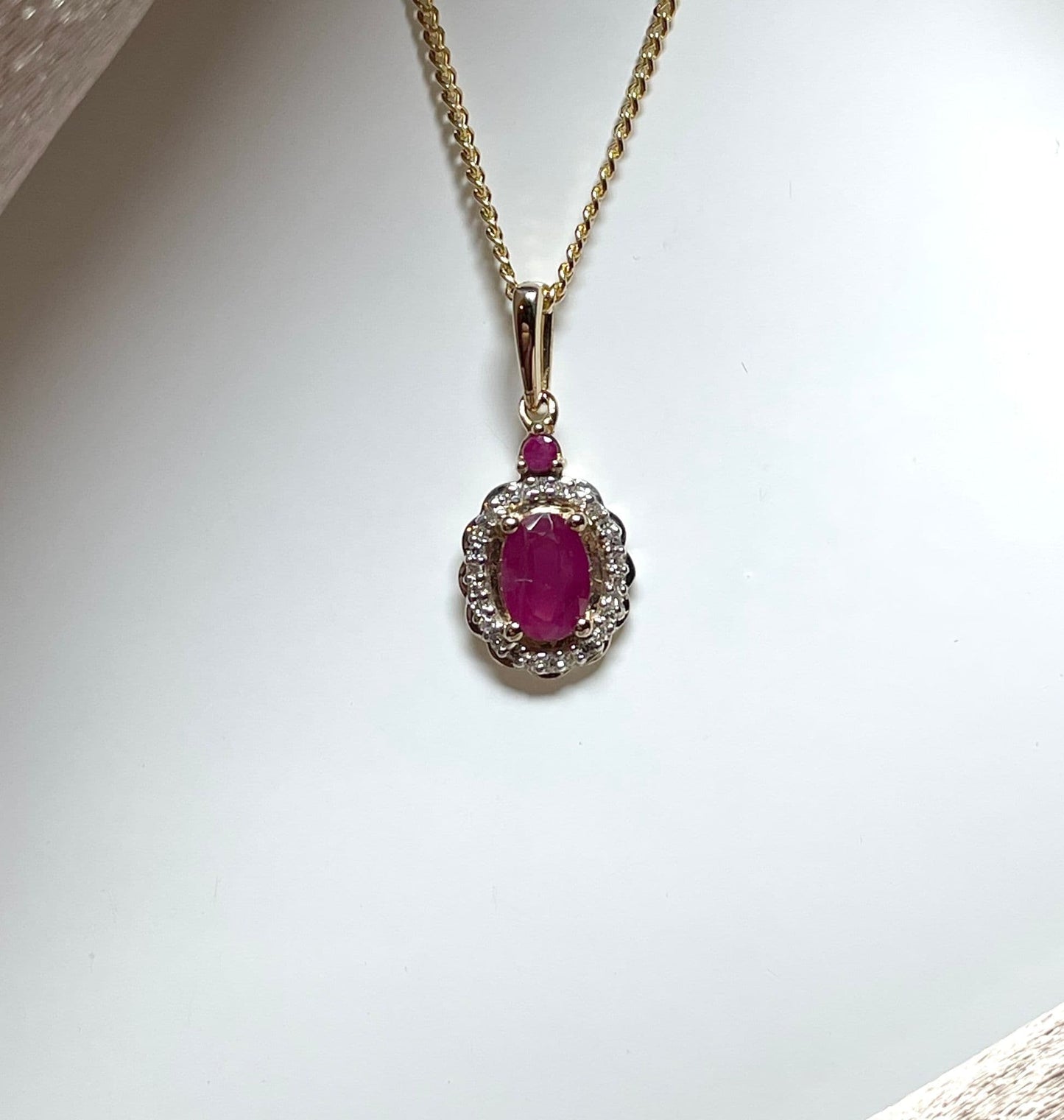 Oval red ruby and diamond necklace yellow gold