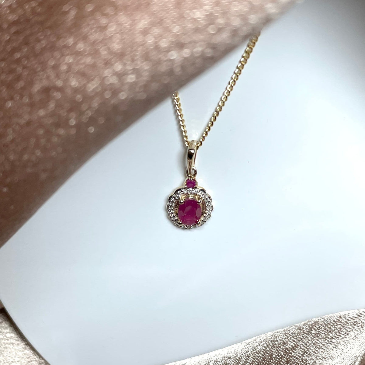 Oval red ruby and diamond necklace yellow gold