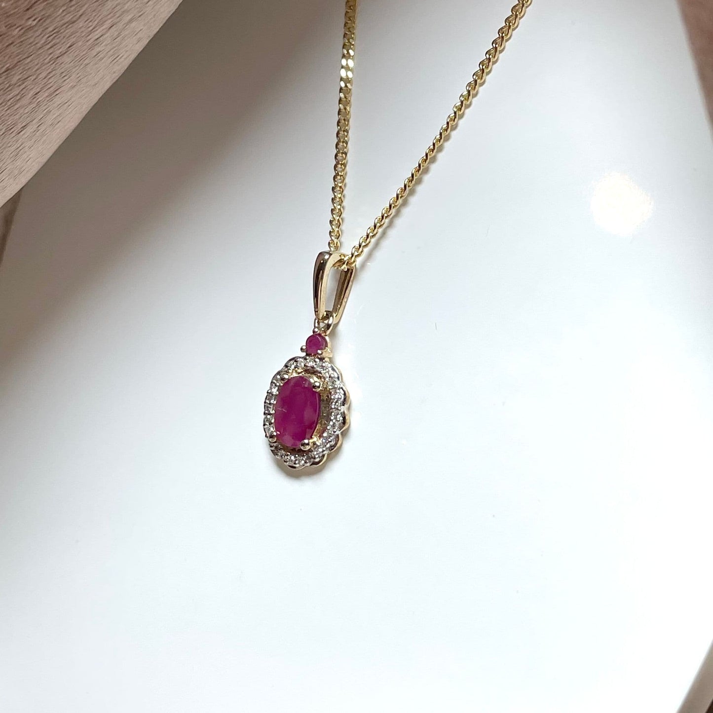 Oval red ruby and diamond necklace yellow gold