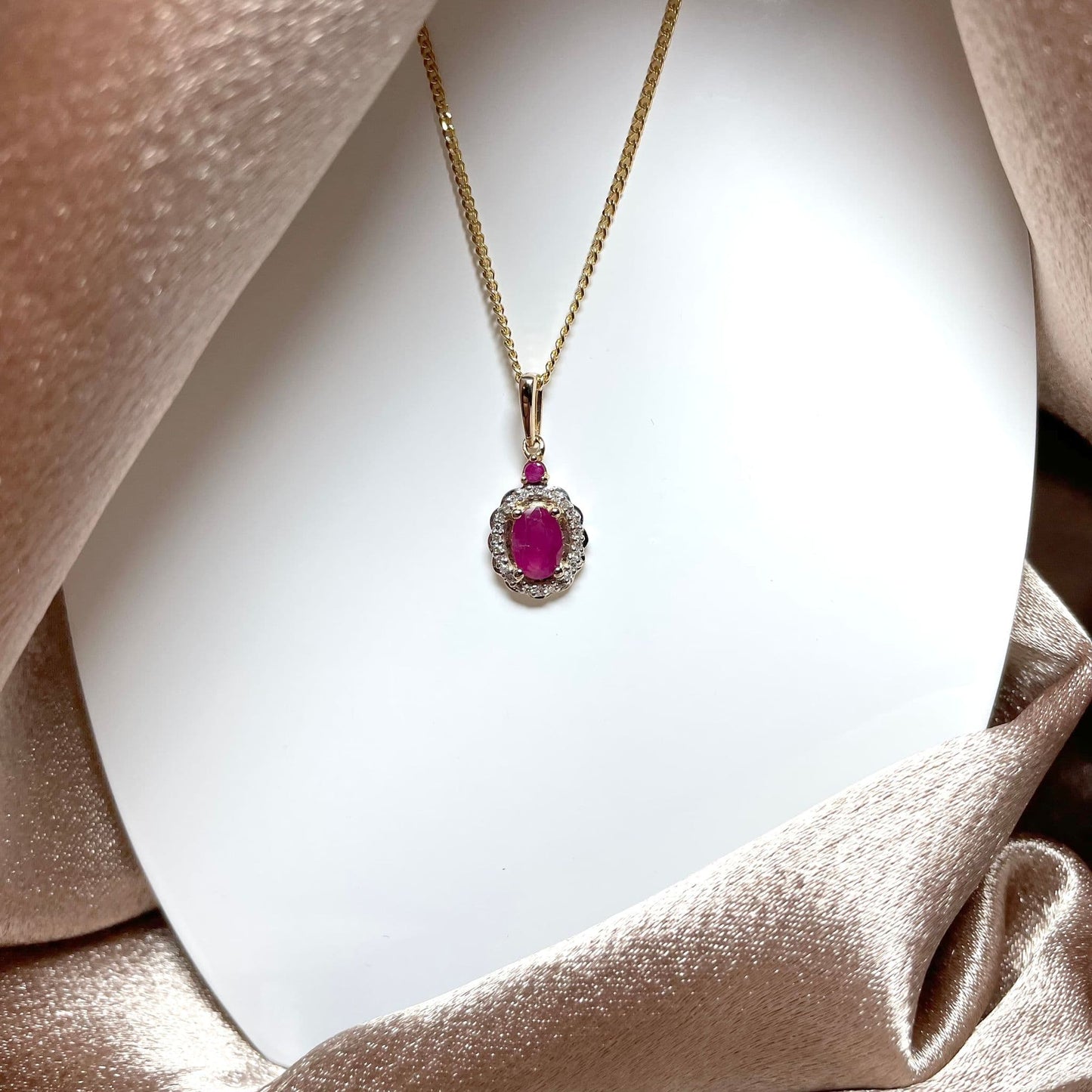 Oval red ruby and diamond necklace yellow gold