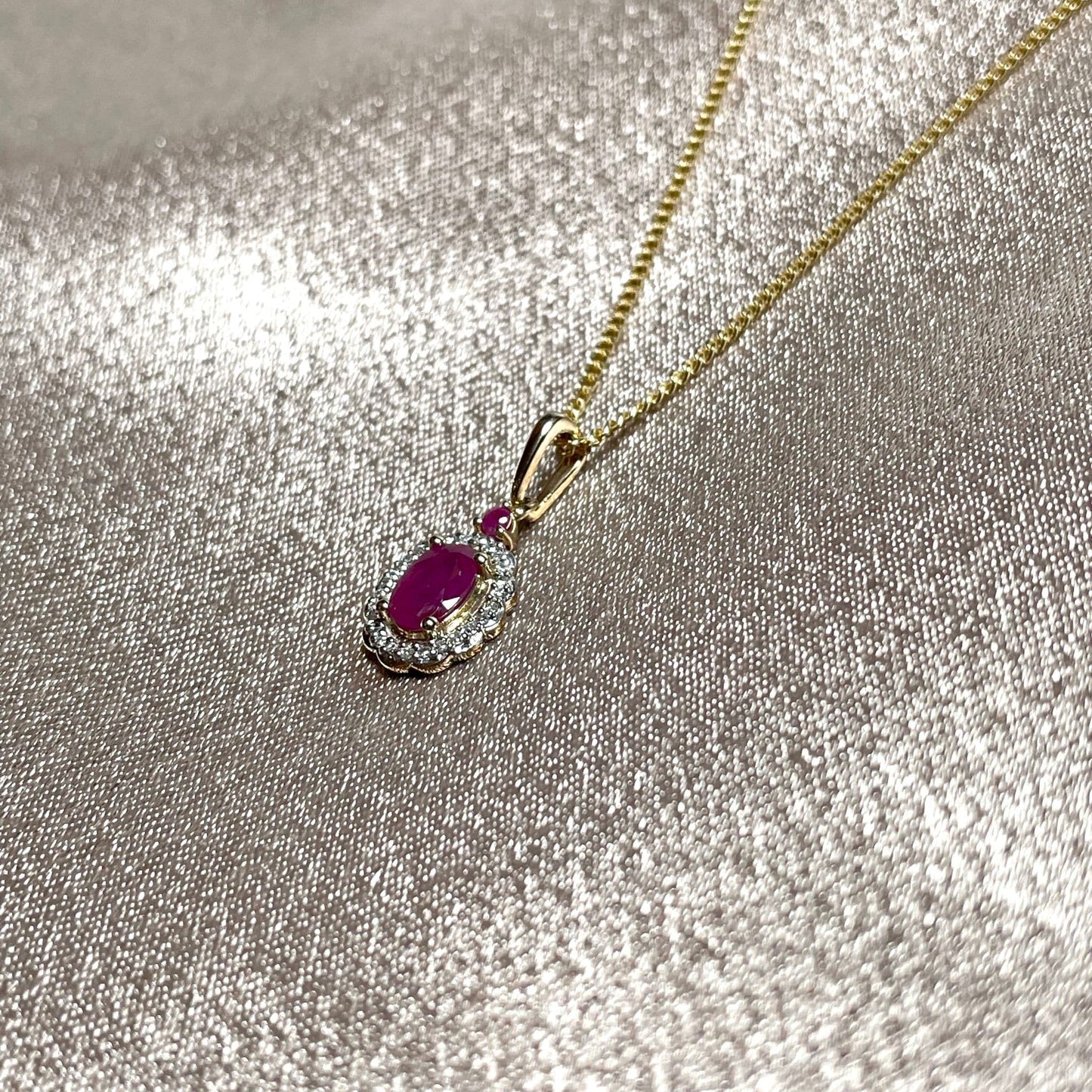 Oval red ruby and diamond necklace yellow gold