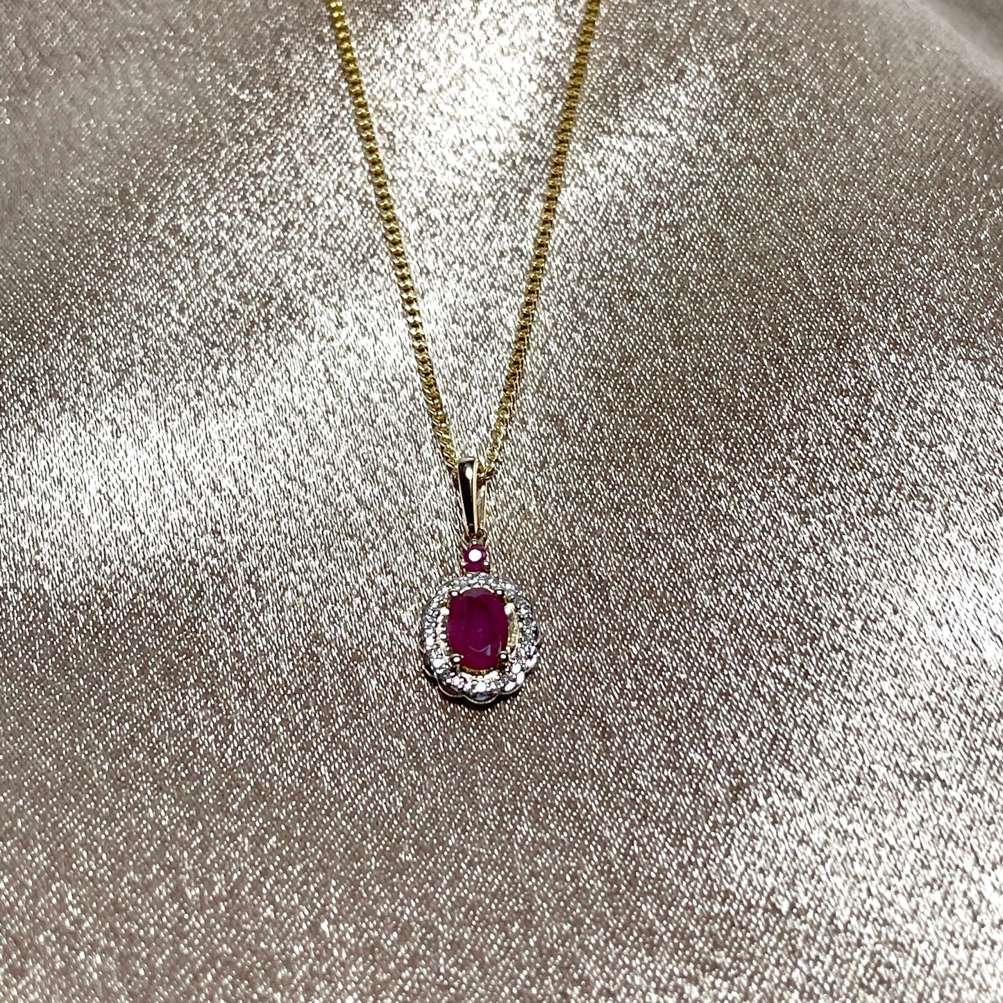 Oval red ruby and diamond necklace yellow gold