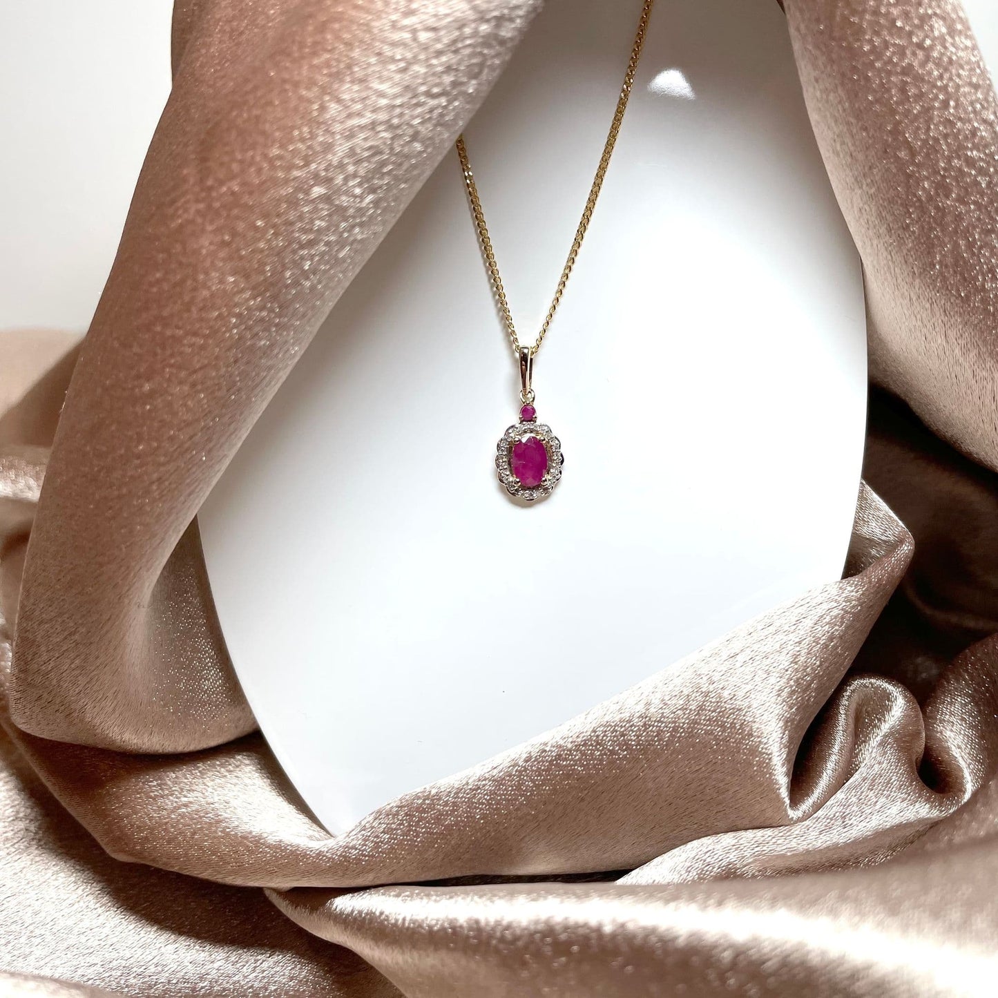 Oval red ruby and diamond necklace yellow gold