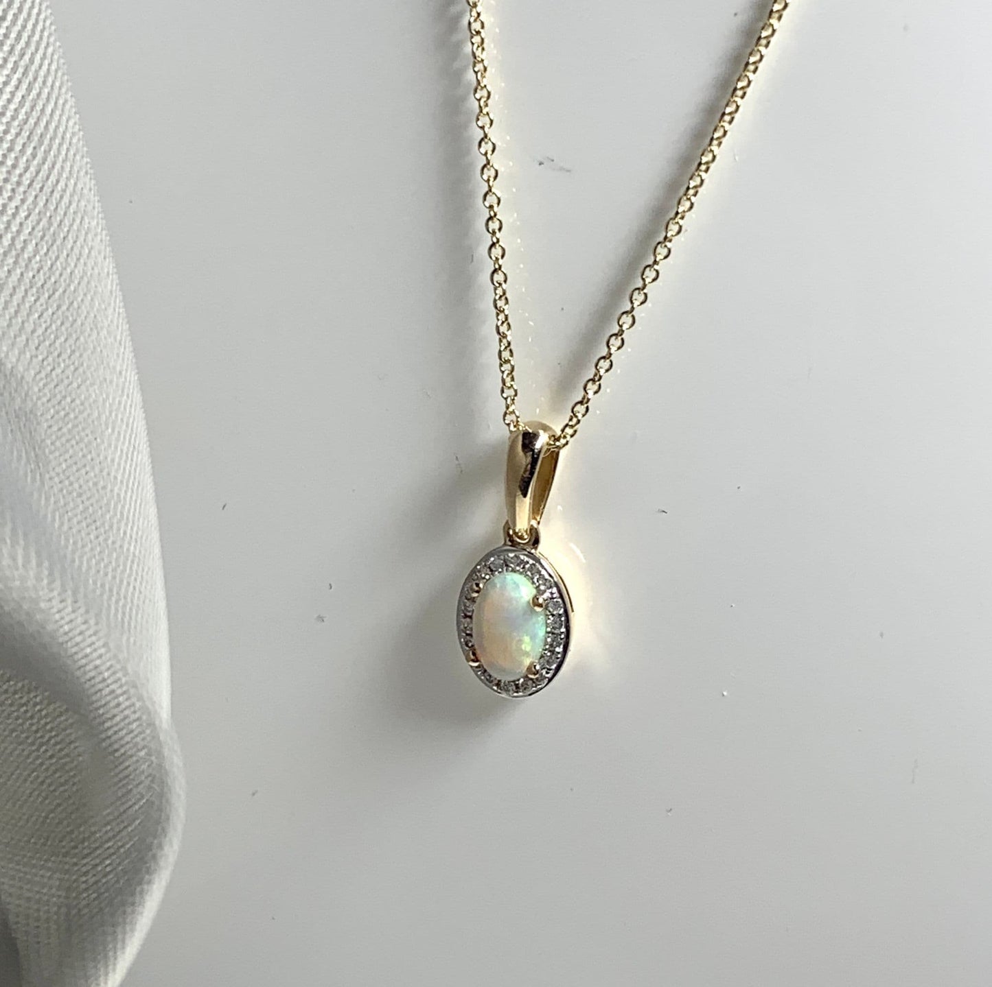 Oval shaped opal and diamond yellow gold cluster necklace