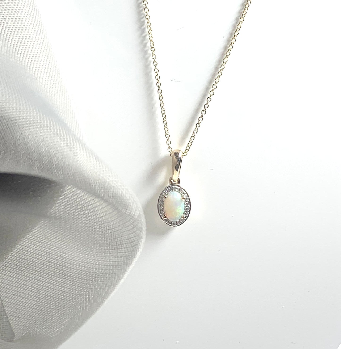 Oval shaped opal and diamond yellow gold cluster necklace