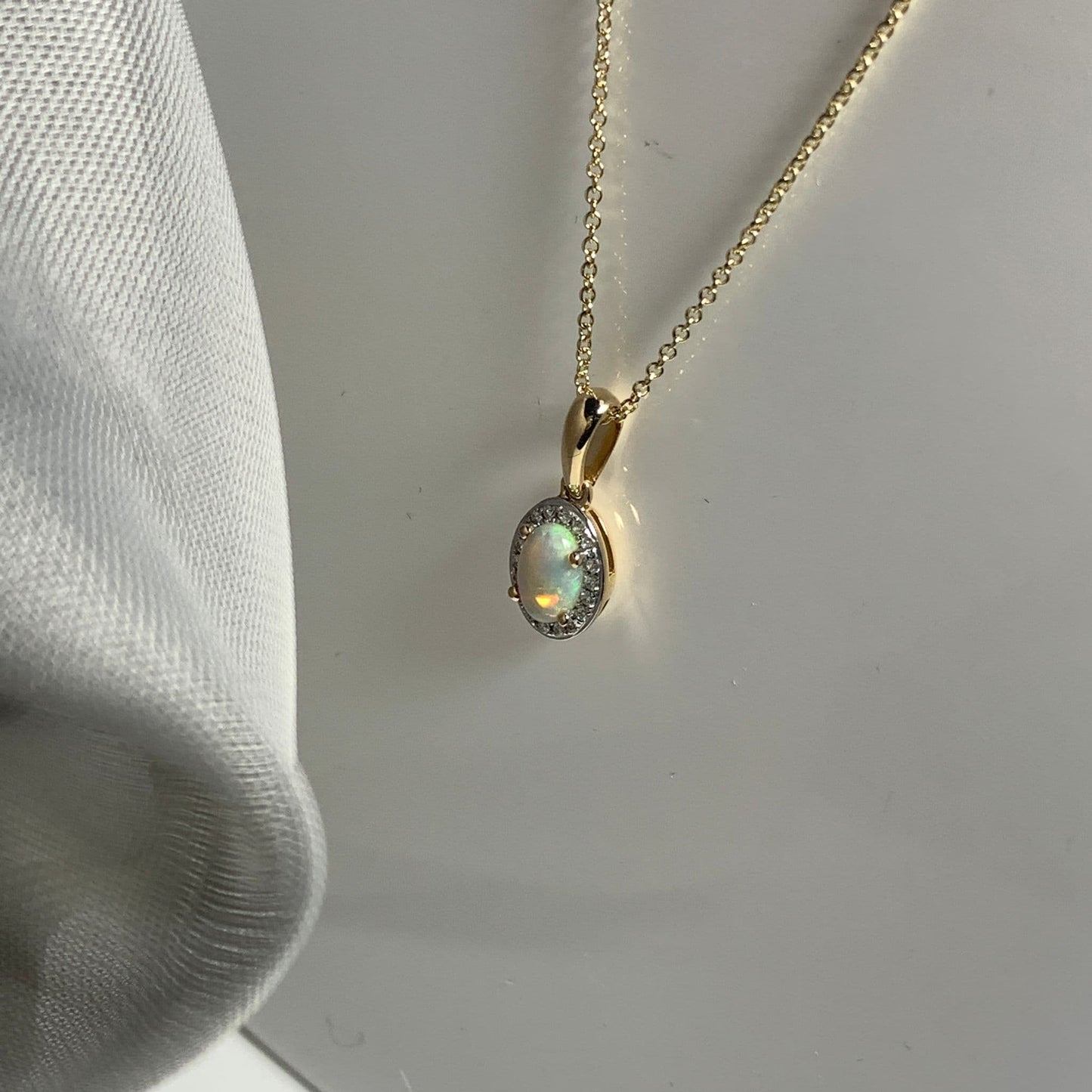 Oval shaped opal and diamond yellow gold cluster necklace