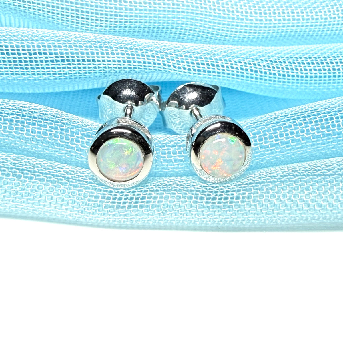 Pair of real opal earrings round white gold stud smooth rubbed over setting